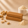 Two ntty refrigerated peanut butter bars with scatted peanuts and grass-fed bone broth protein powder.