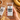 A hand holding refrigerated banana bread protein bar with a bar and scattered ingredients in the background.