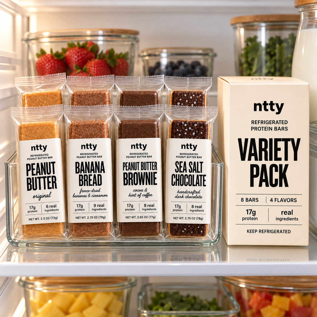 ntty protein bars lined up in a clear tray on a refrigerator shelf next to a Variety Pack box