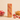 An unwrapped ntty refrigerated strawberry swirl bar with scattered freeze-dried strawberries and a bowl of creamy peanut butter.