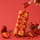 House-made strawberry mixture being poured over a ntty strawberry swirl protein bar with scattered strawberries.