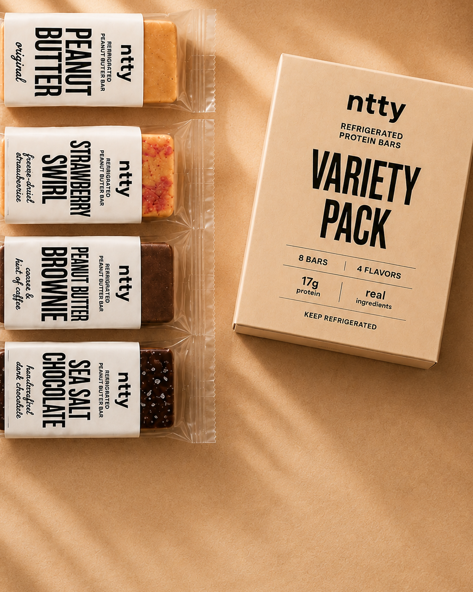 A variety pack of ntty refrigerated peanut butter protein bars. The flavors shown are peanut butter, strawberry swirl, peanut butter brownie and sea salt chocolate.
