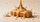 Handcrafted peanut butter bar covered in a pour of creamy peanut butter with roasted peanuts scattered around it.